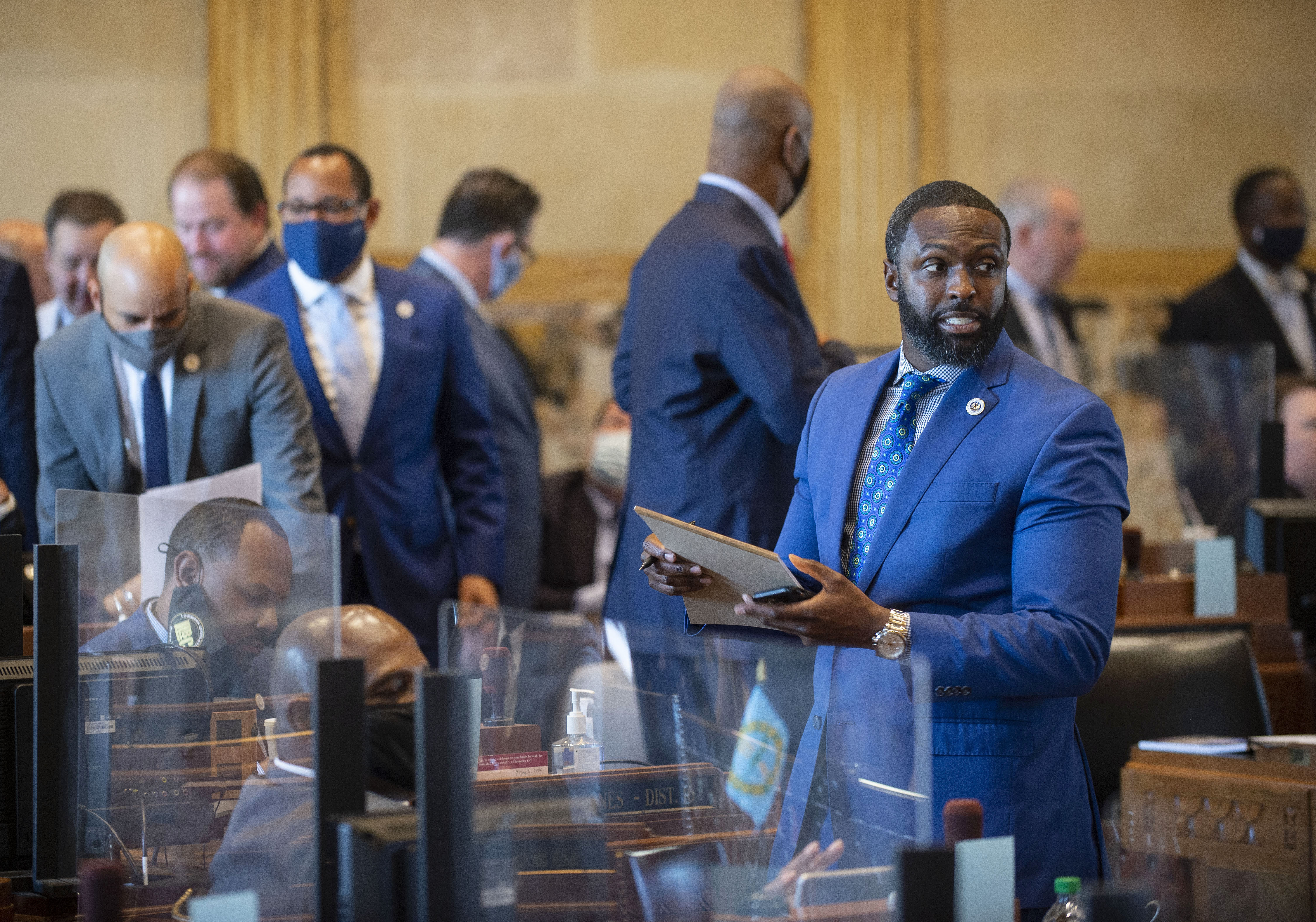 Louisiana state Rep. Ted James, D-Baton Rouge, right, and other representatives talk on the House floor on April 12, 2021, at the Capitol. (Photo by Travis Spradling, The Advocate) 